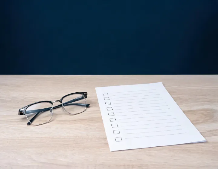 Browline glasses prescription brief checklist on a sourcing desk